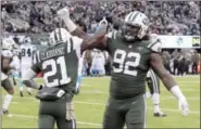  ?? BILL KOSTROUN — THE ASSOCIATED PRESS FILE ?? In this Nov. 26photo, New York Jets defensive end Leonard Williams (92) and cornerback Morris Claiborne (21) celebrate during the second half of the team’s NFL football game against the Carolina Panthers in East Rutherford, N.J.