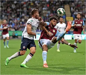  ?? PICTURE: Jan Kruger/getty Images ?? Bath-born Tyrone Mings’ Aston Villa, pictured battling Bolton Wanderers’ Dion Charles during last week’s Carabao Cup tie, will face Manchester United in the third round following the draw last Wednesday night. Mings missed Villa’s defeat to West Ham at the weekend after falling ill before the match