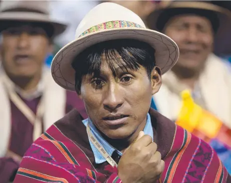  ?? Pictures: AP ?? PATIENT FOR PONTIFF: An indigenous leader from Potosi, Bolivia, waits for the arrival of Pope Francis ( below).