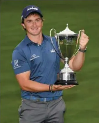  ??  ?? Paul Dunne of Ireland with the winner’s trophy after the final round of the British Masters.