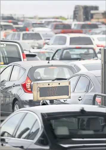  ?? PHOTOS BY LAURA A. ODA — STAFF PHOTOGRAPH­ER ?? Bumper-to-bumper traffic jams the Bay Bridge toll plaza during the morning commute in Oakland on Thursday. A measure to raise bridge tolls by $3to pay for $4.45billion in transporta­tion projects passed Tuesday.