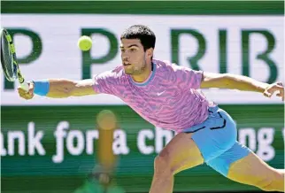  ?? /Jayne KaminOncea/USA Today Sports ?? Forging ahead: Carlos Alcaraz hits a shot in his fourth round win over Fabian Marozsan at Indian Wells.