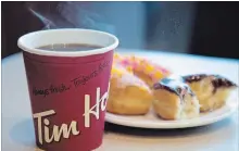  ?? JONATHAN HAYWARD THE CANADIAN PRESS ?? Tim Hortons parent company pleased with sales growth.