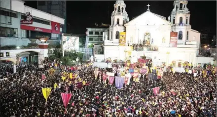  ?? NOEL CELIS/AFP ?? Catholic devotees gather at the Quiapo Church during an annual procession in Manila on Tuesday. President Duterte’s effort to provide free contracept­ion to 6 million Filipino women will likely face strong resistance from the Catholic Church.