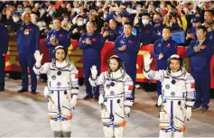  ?? (Carlos Garcia Rawlins/Reuters) ?? THREE CHINESE astronauts wave during a ceremony ahead of being sent on China’s second crewed mission to build its own space station on Friday. Beijing wants to develop anti-satellite weapons and rapidly narrow America’s lead in space technology.