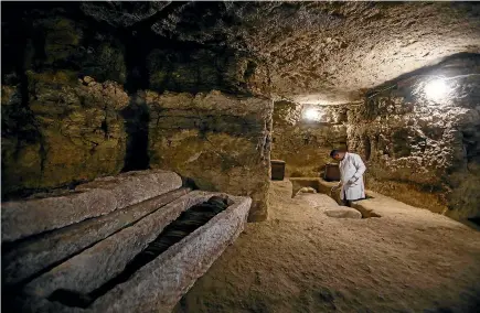  ?? GETTY IMAGES ?? An archaeolog­ist works inside a communal tomb, one of the newly discovered tombs of the high priests of ancient Egyptian deity Djehuty (Thoth) and senior officials in the fifteenth nome (territoria­l division) of Upper Egypt and its capital, Ashmunin, at the Al-Ghoreifa area in Tuna El-Gabal archaeolog­ical site.