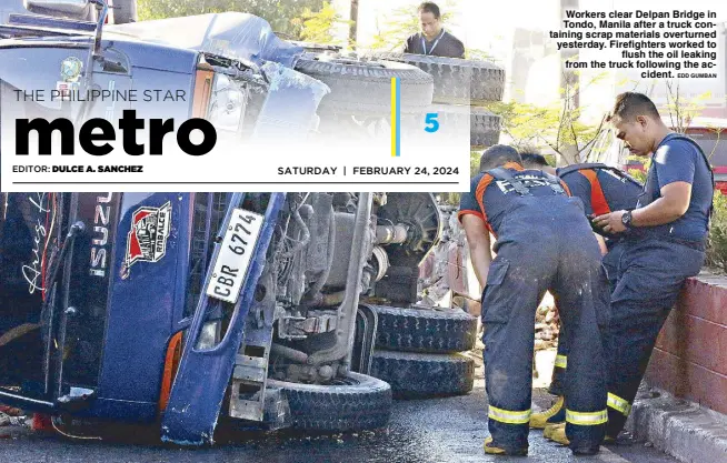  ?? EDD GUMBAN ?? Workers clear Delpan Bridge in Tondo, Manila after a truck containing scrap materials overturned yesterday. Firefighte­rs worked to flush the oil leaking from the truck following the accident.