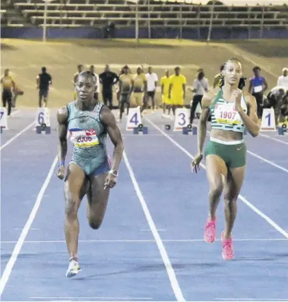  ?? (Photo: Joseph Wellington) ?? Shashalee Forbes (left) crosses the line ahead of Saba Williams to win the women’s 60m sprint at the Queen’s/grace Jackson Developmen­t Meet at the National Stadium in Kingston on Saturday.