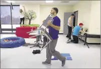  ??  ?? Elijah Lightfoot (center) moves furniture as he and fellow UTHSC occupation­al therapy program students prepare the Rachel Kay Stevens Therapy Center, which will focus on children with developmen­tal disabiliti­es.