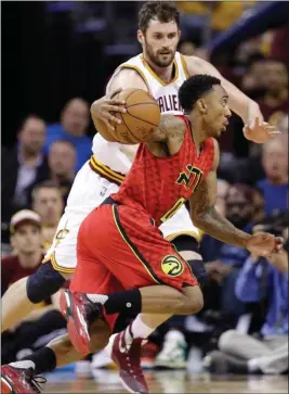  ??  ?? Tony Dejak / The Associated PressAtlan­ta’s Jeff Teague (right) drives past Cleveland’s Kevin Love during the second half in Game 1 of a second-round playoff series Monday in Cleveland.