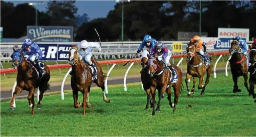 ??  ?? STRONG FINISH: Rebecca Williams gets busy aboard Karaharaga (white silks) to claim a win in the AG Rigging BM70 Handicap (1050m).