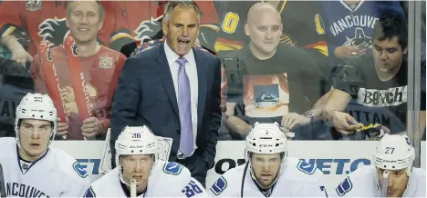  ?? JEFF McINTOSH/THE CANADIAN PRESS ?? The Vancouver Canucks, under head coach Willie Desjardins, centre, don’t seem to be built for the rigours of the playoffs.