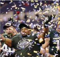  ??  ?? Michigan State’s Denicos Allen holds up the trophy following the Spartans’ Big Ten Conference championsh­ip win over Ohio State last December. The Buckeyes are looking to gain some respect with a win in East Lansing.