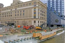  ?? AP PHOTOS/KRISTEN NORMAN ?? Constructi­on workers labor Jan. 31 along the river downtown in Grands Rapids, Mich. Michigan will be a key state in determinin­g the outcome of the upcoming 2024 presidenti­al election, with the economy on the minds of many voters in the state.