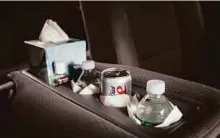 ?? New York Times ?? Beverages and toiletries provided by Uziel Santos to lift his customer ratings on ride-hailing apps, in his van in New York.