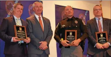  ?? MARIAN DENNIS – DIGITAL FIRST MEDIA ?? From left, Upper Merion Police Detective Brendan Dougherty, Officer Christophe­r Dolga and Detective Blaine Leis were honored by Montgomery County District Attorney Kevin Steele, second from left, for their work on a case involving a dangerous criminal...