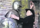 ?? PHOTOS: AFP ?? Gerry Halman, aka Lord Gregarious, stands next to a mannequin dressed in combat armour in his “Olt Stoutenbur­ght” Castle (Old Naughty Citadel) that he has been building over the last 34 years in his back garden, in Blesdijke.