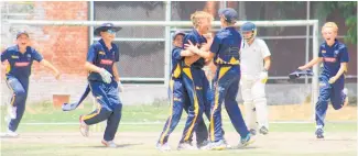  ?? Photo / Gillian Scott ?? The North Shore Cricket Club under-13s celebrate a hat-trick to Freddy Birch in Delhi.