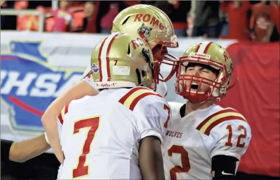  ?? Jeremy Stewart / Rome News-Tribune ?? Rome quarterbac­k Knox Kadum (right) lets out a yell as he celebrates with teammates Xavier Roberts (7) and Zach Kadum following his touchdown late in Friday’s game. Rome defeated Buford 16-7 to win the Class 5A state championsh­ip game Friday at the...