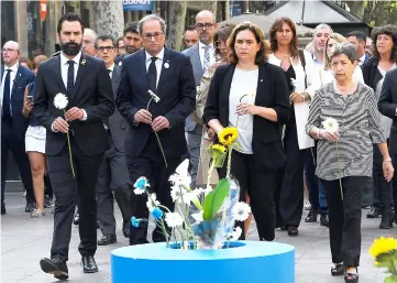  ??  ?? (From left) Catalan regional Speaker Roger Torrent, Catalan regional President Quim Torra, Colau and Spanish government’s delegate in Catalonia Teresa Cunillera take part in a floral tribute at the Miro’s mosaic in La Rambla avenue in Barcelona during a ceremony marking first anniversar­y of attacks in Barcelona and Cambrils. — AFP photo