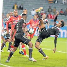  ?? Picture: GALLO ?? BALANCING ACT: Orlando Pirates player Issa Sarr lashes out at the ball during their PSL clash against Tuks in Soweto last night