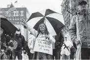  ?? New York Times file photo ?? Protesters rally May 14 at the state Capitol in Lansing, Mich. Gov. Gretchen Whitmer is asking for voluntary rather than mandatory precaution­s.