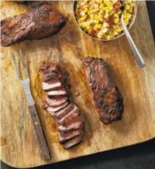  ?? CARL TREMBLAY/AMERICA’S TEST KITCHEN VIA AP ?? The recipe for Grilled Southweste­rn Steak Tips With Tangy Corn Relish appears in the America’s Test Kitchen cookbook “Just Add Sauce.”