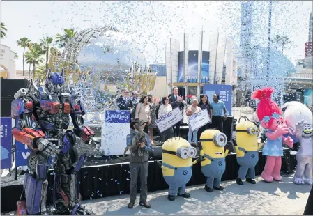  ?? PHOTOS BY DAVID CRANE—STAFF PHOTOGRAPH­ER ?? Gov. Gavin Newsom, center, joins a cast of characters from Universal Studios Hollywood and other officials as Newsom announces that California is reopening its economy Tuesday following 15months of pandemic restrictio­ns.