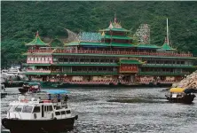  ?? Kin Cheung / Associated Press ?? The Jumbo Floating Restaurant was towed away in Hong Kong last week after its parent company failed to find a new owner.