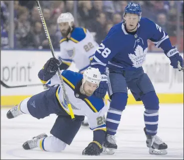  ?? STAN BEHAL/TORONTO SUN ?? Blues’ Chris Thorburn gets taken down by Leafs winger Connor Brown during last night’s game.