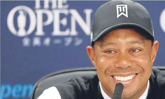  ?? Picture: Getty Images. ?? A smiling Tiger Woods faces the world’s press at St Andrews yesterday.