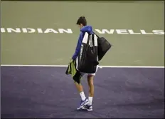  ?? AP PHOTO/MARK J. TERRILL ?? In this March 11, 2019, file photo, Novak Djokovic, of Serbia, walks off the court during a rain break in his match against Philipp Kohlschrei­ber, of Germany, at the BNP Paribas Open tennis tournament in Indian Wells.