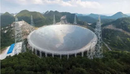  ??  ?? PINGTANG, China: This picture taken on September 24, 2016 shows the Five-hundred-meter Aperture Spherical Radio Telescope (FAST). — AFP