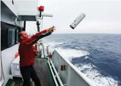  ??  ?? Marine mammal acousticia­n Dr Brian Miller launches a sonobuoy, which will monitor whale calls in the Southern Ocean, where he’s studying blue whale population numbers.