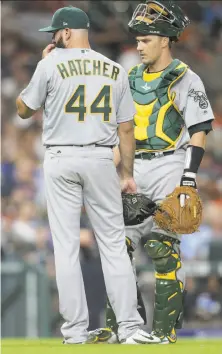  ?? Elizabeth Conley / Houston Chronicle 2017 ?? A’s reliever Chris Hatcher and catcher Dustin Garneau on the mound. Teams get one extra mound visit for each extra inning.