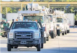  ?? PHOTOS BY JOE BURBANK/ORLANDO SENTINEL ?? Orlando Utilities Commission crews head to Lafayette, La., on Thursday to assist with power restoratio­n in the wake of the devastatio­n from Hurricane Laura.