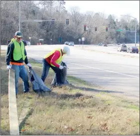  ?? (NWA Democrat-Gazette/Keith Bryant) ?? Bella Vista residents John and Chris Rice load up garbage March 20 during the Six in Sixty highway cleanup. Chris Rice said they’re retired and wanted to give back to their community. “We love it here, so we want to keep it good,” she said.