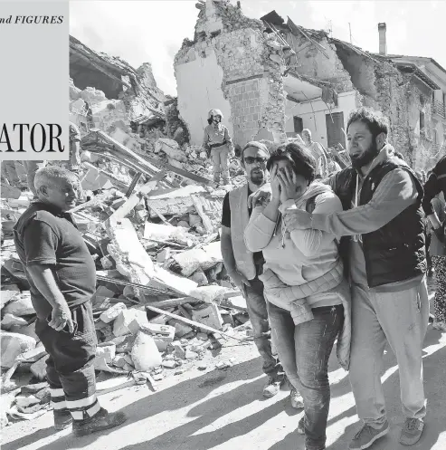  ?? ALESSANDRA TARANTINO / THE ASSOCIATED PRESS ?? A woman is comforted as she walks through the rubble following the earthquake in Amatrice, Italy, that collapsed houses on top of residents as they slept. “It was one of the most beautiful towns of Italy and now there’s nothing left,” one woman said as...