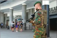  ?? FRANCOIS LENOIR / REUTERS ?? A Belgian soldier stands guard outside Brussels central railway station after a suicide bomber was shot dead in Brussels on Wednesday.