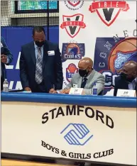  ?? Connecticu­t Cobras / Contribute­d photo ?? Troy Bradford, center, signs a contract to become the first basketball coach of The Connecticu­t Cobras of The Basketball League on August 16 at the Boys & Girls Club in Stamford. At left is team owner Anthony Hill. At right is team president Ed Battle.