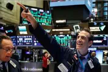  ?? Richard Drew/Associated Press ?? Trader Gregory Rowe reacts at Tuesday’s closing on the floor of the New York Stock Exchange.