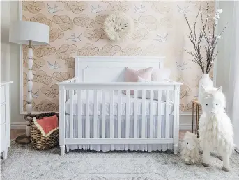  ?? LECLAIR DECOR ?? Neutral tones and a less aggressive print are the hallmarks of today’s wallpaper. Sacha and Melissa Leclair of Leclair Decor created a framed wallpaper wall in soft hues in their daughter’s nursery.