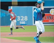  ?? JON BLACKER THE CANADIAN PRESS ?? Phillies’ Rhys Hoskins, left, rounds the bases after hitting a solo homer off of Blue Jays veteran starting pitcher Marco Estrada, right.