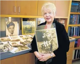  ?? RICH PEDRONCELL­I/AP ?? Diane Capone holds a copy of a photograph of her father, Albert “Sonny” Capone as a young boy and her grandfathe­r Al Capone on display at Witherell’s Auction House in Sacramento, Calif., on Aug. 25.