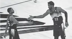  ?? PATRICK BREEN/ARIZONA REPUBLIC ?? The Suns’ Mikal Bridges (25) high-fives Deandre Ayton (22) during the second half at the Phoenix Suns Arena.