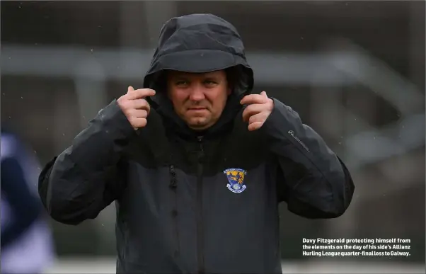  ??  ?? Davy Fitzgerald protecting himself from the elements on the day of his side’s Allianz Hurling League quarter-final loss to Galway.