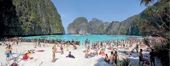  ??  ?? The crowds of tourists on Maya beach, Koh Phi Phi Le, Thailand, have resulted in its closure to give it a chance to recover.