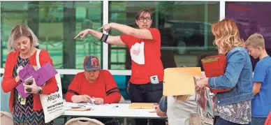  ?? PATRICK BREEN/THE REPUBLIC ?? At Mesa High School on Thursday, Krista Rowley (center) directs teachers on where to sit to count ballots for deciding whether there will be a statewide teacher walkout. Arizona teachers voted in favor of the walkout.