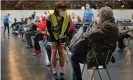  ?? Photograph: Sean Gallup/Getty ?? A vaccine centre worker tends to a patient at the Arena Berlin mass vaccinatio­n centre in the German capital earlier this month.