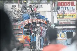  ?? MATIAS DELACROIX — THE ASSOCIATED PRESS ?? Commuters ride a Tap Tap bus in Port-au-Prince, Haiti, Wednesday.